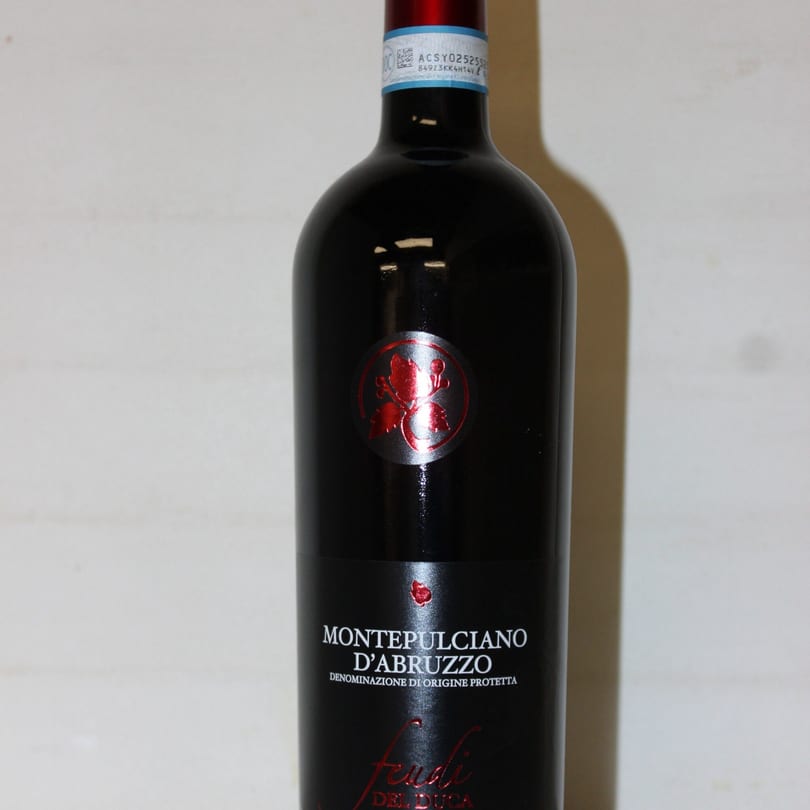 A bottle of Montepulciano d'Abruzzo red wine with a red and silver label.