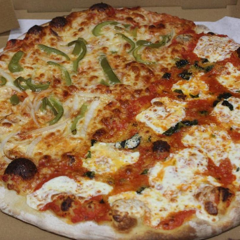 Half green pepper and onion pizza, half Margherita pizza with fresh mozzarella and basil.