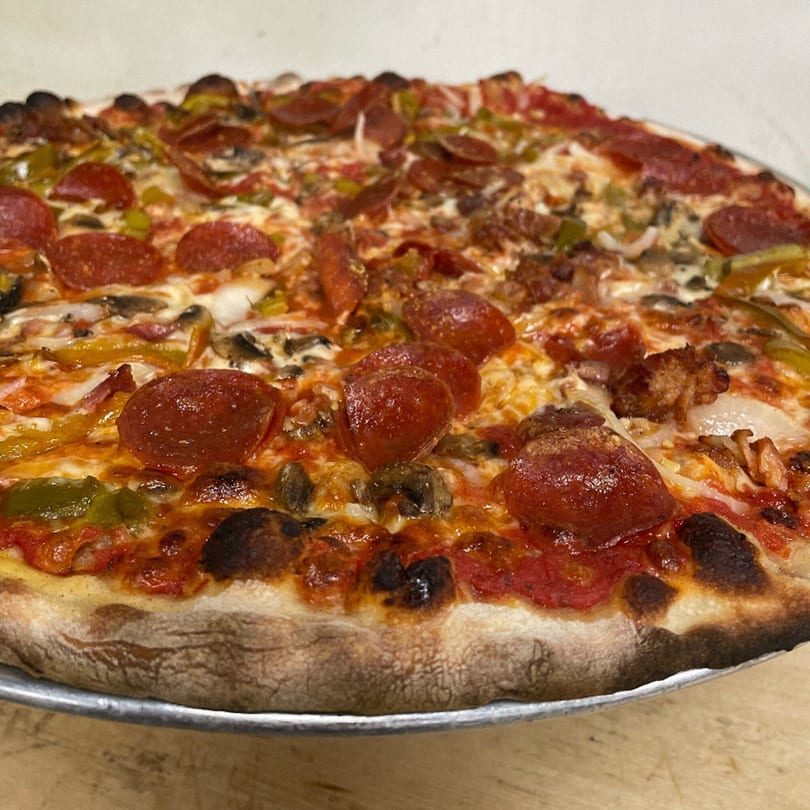 Marco Pizzeria's large, hot Italian pizza with pepperoni, sausage, peppers, onions, and mushrooms.